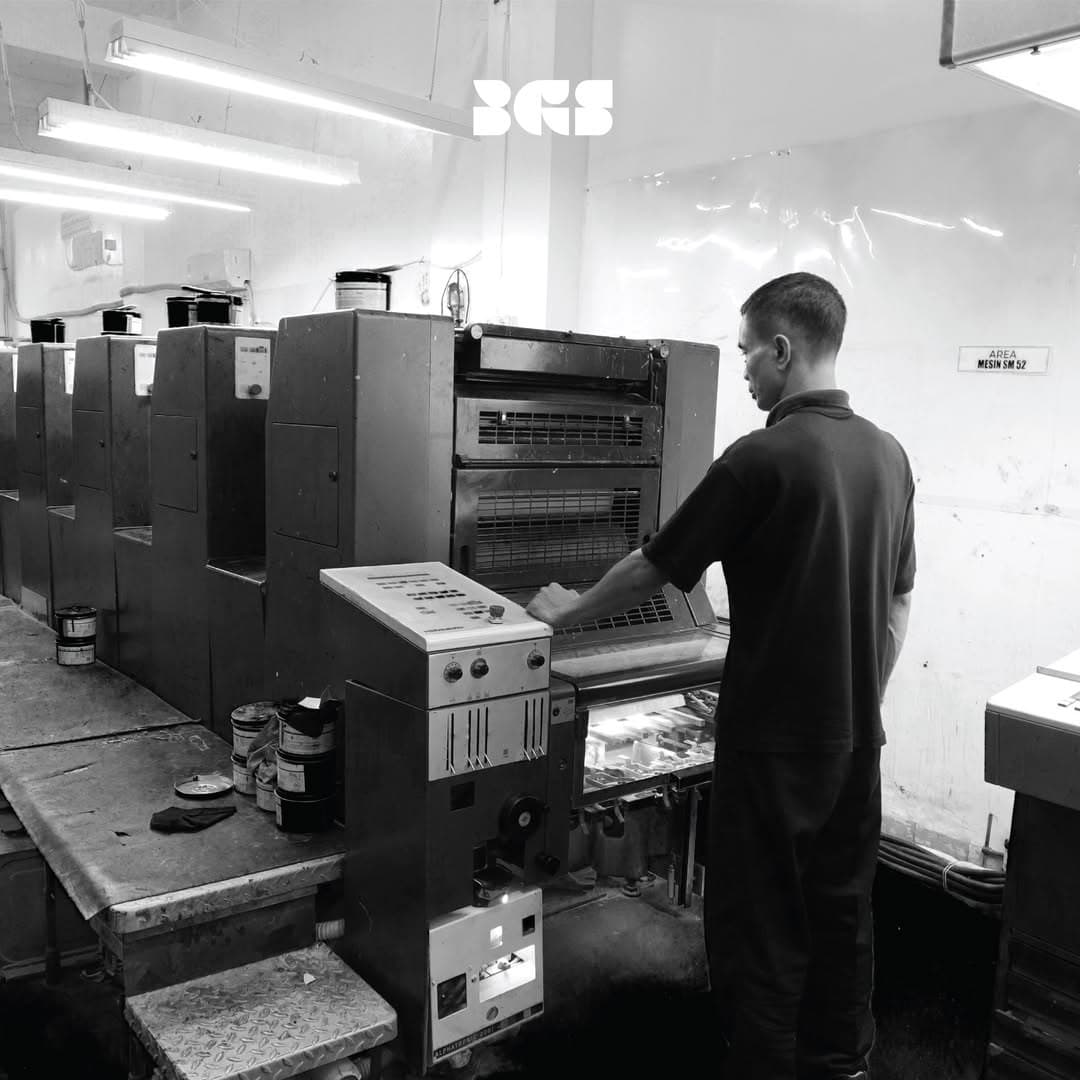 Press operator running an offset printing press at the BGS production facility in Jelambar, West Jakarta
