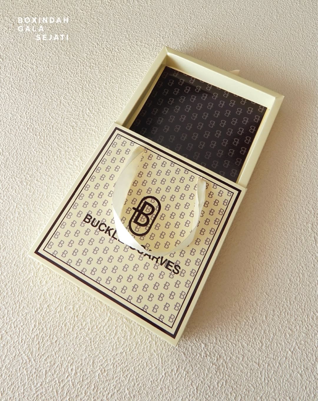 Buckle Scarves gift box with monogram pattern print and ribbon pull, produced by BGS