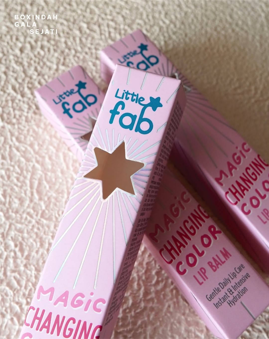 Little Fab lip balm folding cartons with a star-shaped die-cut window and foil detailing
